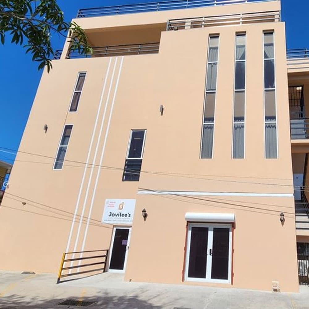 Peach-colored building with large windows and a sign reading "Jovilee's."