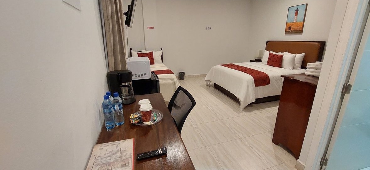 Bedroom with work desk in the foreground.